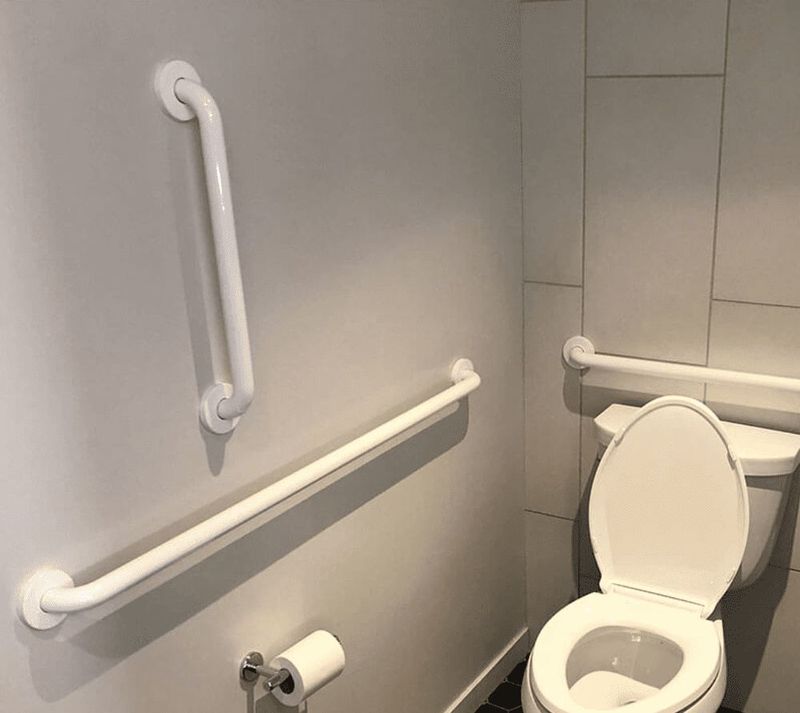 White grab bars installed on white tile